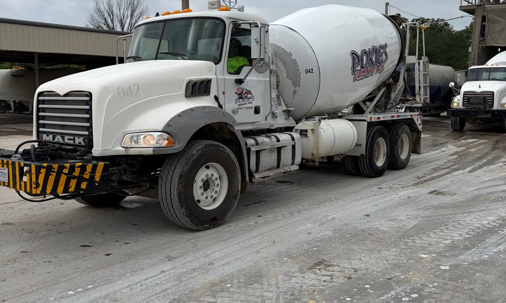 Pokie's Mack mixer truck 042 loaded and rolling out of the batch plant